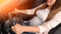 Pregnant driving car. Young smiling pregnancy woman driving car. Safety pregnant young mom driving concept.