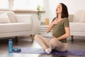 Pregnant european lady engages in meditation and breathing exercise indoor