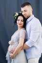 Pregnant european woman with her husband on gray background, young european couple waiting for a child, prenant woman Royalty Free Stock Photo