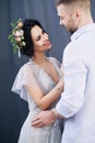 Pregnant european woman with her husband on gray background, young european couple waiting for a child, prenant woman Royalty Free Stock Photo