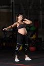 Pregnant female athlete doing hang kettlebell clean and press Royalty Free Stock Photo