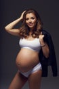 Pregnant female model in sports underwear standing and posing Royalty Free Stock Photo