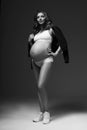 Pregnant female model in sports underwear standing and posing Royalty Free Stock Photo