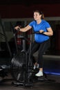 Pregnant woman doing intense workout at gym air bike Royalty Free Stock Photo