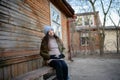 Pregnant girl on the bench. A pregnant young girl is sitting on a bench. The concept of the beginning of autumn and fall of leaves Royalty Free Stock Photo