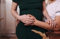 Pregnant girl in  dress holds her hands on her belly Royalty Free Stock Photo