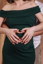 Pregnant girl in  dress holds her hands on her belly Royalty Free Stock Photo