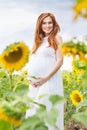 Pregnant girl in the field with sunflowers Royalty Free Stock Photo