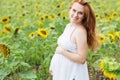 Pregnant girl in the field with sunflowers Royalty Free Stock Photo