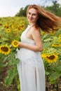 Pregnant girl in the field with sunflowers Royalty Free Stock Photo