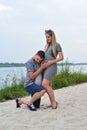 A pregnant girl and a guy walking along the river bank Royalty Free Stock Photo