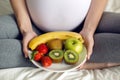 Pregnant girl holding a bowl of fruit Royalty Free Stock Photo