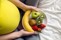 Pregnant girl holding a bowl of fruit Royalty Free Stock Photo