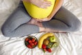 Pregnant girl holding a bowl of fruit Royalty Free Stock Photo