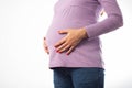 Pregnant girl holding her belly on a white background. Concept of intestinal and vaginal infections during pregnancy