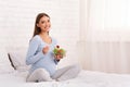 Pregnant Girl Holding Salad In Bowl Sitting In Bed Royalty Free Stock Photo