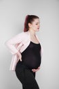 Pregnant girl holding on to her back. Pain, heaviness in the back. Royalty Free Stock Photo