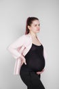 Pregnant girl holding on to her back. Pain, heaviness in the back. Royalty Free Stock Photo