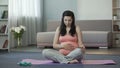 Pregnant girl listening to melodies engaging in spiritual development of fetus