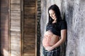 Pregnant girl with mehendi tattoo on her belly