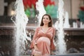 Pregnant girl near the fountain. happy and carefree pregnancy Royalty Free Stock Photo