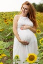Pregnant girl in sunflowers field Royalty Free Stock Photo