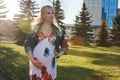 Pregnant girl is walking around the city park in spring Royalty Free Stock Photo