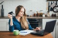 Pregnant girl works at home in self-isolation mode in quarantine and makes online purchases Royalty Free Stock Photo