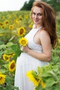 Pregnant happy girl in sunflowers field Royalty Free Stock Photo