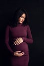 Pregnant happy Woman touching her belly. Pregnant middle aged mother portrait, caressing her belly and smiling close-up. Healthy P Royalty Free Stock Photo