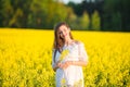 Pregnant happy woman touching her belly. Pregnant middle-aged mother portrait caressing her belly and smiling close-up. Healthy Royalty Free Stock Photo