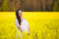 Pregnant happy woman touching her belly. Pregnant middle-aged mother portrait caressing her belly and smiling close-up. Healthy Royalty Free Stock Photo