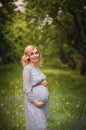 Pregnant happy Woman touching her belly. Pregnant middle aged mother portrait, caressing her belly and smiling close-up. Healthy P Royalty Free Stock Photo