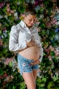 Pregnant happy woman touching her belly. Pregnant young mother portrait, caressing her belly and smiling. Healthy Pregnancy Royalty Free Stock Photo