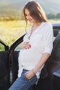 Pregnant happy young woman near car on the nature Royalty Free Stock Photo