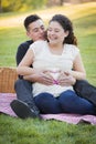 Pregnant Hispanic Couple Making Heart Shape with Hands on Belly Royalty Free Stock Photo