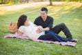 Pregnant Hispanic Couple in The Park Outdoors Royalty Free Stock Photo