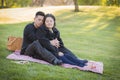 Pregnant Hispanic Couple in The Park Outdoors Royalty Free Stock Photo
