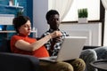 Pregnant interracial couple relaxing and using technology Royalty Free Stock Photo