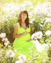 Pregnant lovely woman in flowers Royalty Free Stock Photo