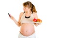 Pregnant making choice between drugs and fruits Royalty Free Stock Photo