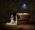 Pregnant Mary Leaning on Manger Royalty Free Stock Photo