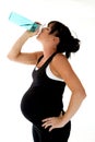 Pregnant model drinking water after her physical fitness workout Royalty Free Stock Photo