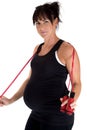 Pregnant model working out with a jump rope