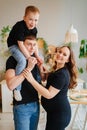 pregnant mom, dad rides son on shoulders. games and relationships with children Royalty Free Stock Photo