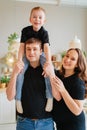 pregnant mom, dad rides son on shoulders. games and relationships with children Royalty Free Stock Photo