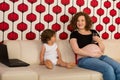 Pregnant mom having conversation with son Royalty Free Stock Photo