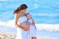 Pregnant mother and daughter on the beach Royalty Free Stock Photo