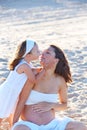 Pregnant mother and daughter on the beach Royalty Free Stock Photo