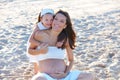 Pregnant mother and daughter on the beach Royalty Free Stock Photo